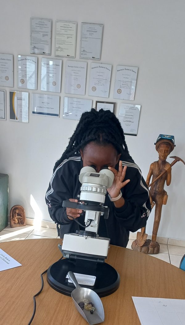 lady-inspecting-diamonds-with-microscope